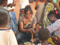 Mulher prepara prato típico do Burkina, feito com farinho de milho e água.