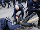 Police wrestle with protesters as they protest at the Olympic torch relay(Photo : Reuters)