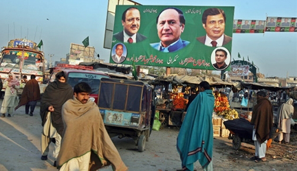Commuters pass by a PML-Q billboard - with  Chaudhry Shujat Hussain depicted in the centre - in Gujrat ( Photo: AFP )
