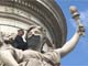 Marie de Cenival putting a beard on a statue, Place de la Republique, Paris(Photo: Mathilde Cannat/La Barbe)