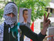 A Hezbollah fighter in front of a poster of Syrian president Bashar al-Assad, 9 May 2008.(Photo: Reuters)