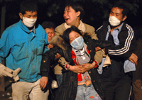 A woman faints after hearing that her daughter was killed when a school collapsed in the earthquake-hit Hanwang town of Mianzhu (Photo: Reuters)