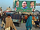 Commuters pass by a PML-Q billboard in Gujrat( Photo : AFP )