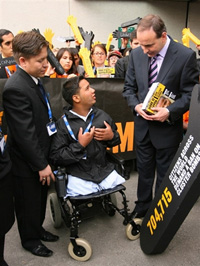 An Afghani cluster bomb victim with Irish Foreign Minister Micheal Martin.(Photo : AFP)