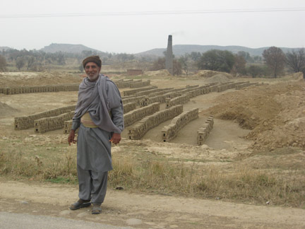 Mohamed Yunus in front of the brickworks in his village near Jehlum (Photo: Tony Cross)
