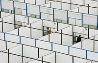 Workers look into temporary housing being built in Dujiangyan, Sichuan Province(Photo: Reuters)