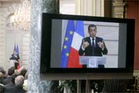 President Sarkozy on a giant television screen as he delivers his speech(Photo: Reuters)