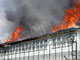 Flames and smoke rise from the burning Administrative Detention Center of Vincennes (CRA) on June 22, 2008(Photo: AFP)