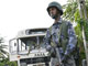 A solider guards the wreckage of a bus near Colombo on June 8, 2008.(Photo: Reuters)