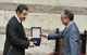  Nicolas Sarkozy (L) receives a gift from the Speaker of the Parliament Dimitri Sioufas(Photo: Reuters)