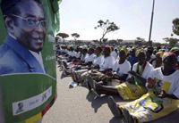 Supporters chant in front of a poster of Zimbabwean President Robert Mugabe(Credit: Reuters)