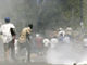 Supporters of Haiti's former president Jean Bertrand Aristide take cover from tear gas thrown by national police during a demonstration demanding the return of the ousted Aristide, in front of the National palace in Port-au-Prince July 15, 2008. REUTERS/Eduardo Munoz (HAITI)(Photo: Reuters)