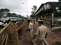 Policemen stand guard at the Madivala bus stand where a woman reportedly died in a bomb blast in Bangalore 25 July 2008.