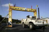 A UN vehicle passes an arch set up by Hezbollah supporters(Photo: Reuters)