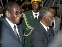 Thabo Mbeki (R) is greeted by Robert Mugabe in Harare.(Photo: Reuters)