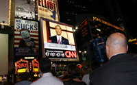 Spectators watch a live broadcast of Obama in New York's Times Square (Photo: Reuters)
