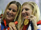 Gold medallist Rebecca Adlington (R) of Britain holds up her medal with bronze medallist Joanne Jackson of Britain after the women's 400 meters freestyle swimming final 