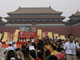 Torchbearer Yang Liwei (L), China's first astronaut, carries the Olympic flame outside the Forbidden city. (Photo: Reuters)