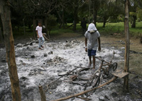 A boy looks at his bicycle that was burned along with his house by MILF fighters.(Photo: Reuters)