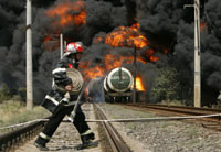 A firefighter in front of the fuel train that exploded Sunday(Photo: Reuters)