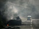 A minibus passes a destroyed Georgian armoured vehicle near the town of Gori some 80 km from Tbilisi, August 11, 2008. (Reuters)