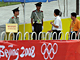 Security personnel check the identification of visitors in front of the National Stadium also known as the Bird's Nest in Beijing on August 5, 2008 ahead of the Beijing 2008 Olympic Games. (Photo : AFP)