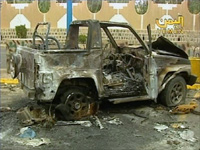 A burnt car sits outside the US embassy in Sanaa.(Photo: Reuters)