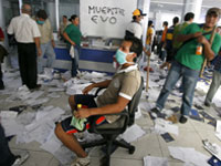 A Bolivian demonstrator sits in a state office during a strike in Santa Cruz(Photo: Reuters)