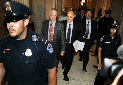US Treasury Secretary Henry Paulson (c) exits a meeting at the Capitol building.(Photo: Reuters)