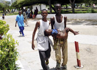 A wounded child is carried to a hospital in Mogadishu by his brothers(Photo: Reuters)