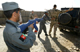 An Afghan National police officer aims a mock AK-47 assault rifle during a drill on how to perform a car check against a German Bundeswehr army soldier of the International Security Assistance Force (ISAF) in the German army camp in Feyzabad, north of Kabul, 23 September 2008. REUTERS/Fabrizio Bensch (Photo: Reuters)