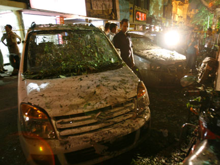 A man looks at a damaged car at the site of the bomb blast in New Delhi(Photo: Reuters)