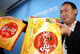 Han Gwon-woo, an official of the Korea Food and Drug Administration (KFDA), shows snacks in which melamine was found in Seoul  25 September 2008. Shares in Crown Confectionary tumbled on Thursday morning after the South Korean government said melamine was found in a snack manufactured by one of its units. KFDA said in a statement on Thursday that it had found melamine in rice cookies made by Crown unit Haitai Confectionary, which were produced in China. REUTERS/Park Jong-min/Newsis (Photo: Reuters)