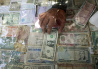 Top dollar - a currency dealer in Karachi(Photo: Reuters)