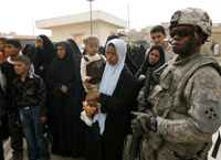 A US soldier stands guard during Eid al-Fitr celebrations in southern Baghdad(Photo: Reuters)