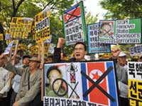 South Korean protestors with defaced portraits of Kim Jong-Il. (Photo: AFP)