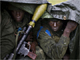 Congolese government (FARDC) troops take shelter from the rain in Kibati.(Photo: Reuters)