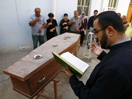 A priest performs funeral rites for a Christian resident killed in a bomb attack on Wednesday in northern Baghdad(Photo: Reuters)