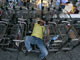 An anti-government protester sleeps on luggage trolleys in Bangkok's Don Muang airport(Photo: Reuters)