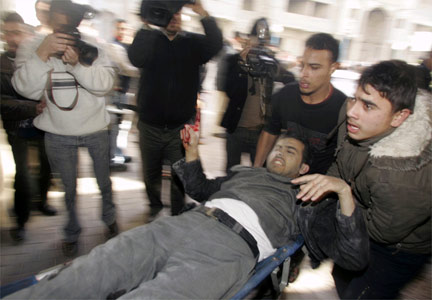 A wounded Palestinian man is carried to hospital.(Photo: Reuters)