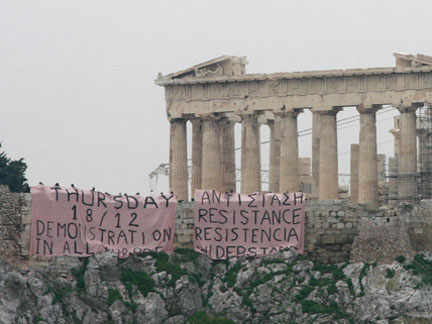 Protesters hold a banner at the hill of the Acropolis in front of the Parthenon in Athens on Wednesday(Photo: Reuters)