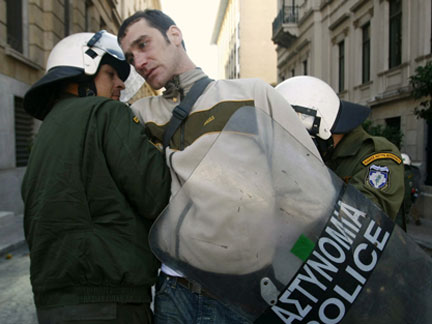 Protester detained by the police during a rally in Athens.(Photo: Reuters)