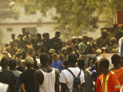 People watch as Guinean soldiers on armoured vehicles patrol the streets of the capital Conakry on Tuesday(Photo: Reuters)