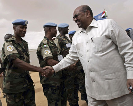Sudan's President Omar Hassan al-Bashir shakes hands with United Nations-African Union Mission in Darfur in July.(Photo : Reuters)