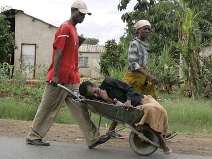 A sick woman is taken in a wheelbarrow to a clinic in Harare on Friday(Photo: Reuters)