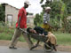A sick woman is taken in a wheelbarrow to a clinic in Harare on Friday(Photo: Reuters)
