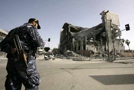 A Hamas police officer stands near the parliament building destroyed during Israel's offensive in Gaza(Photo: Reuters)