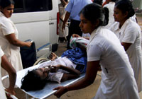 A Tamil child is rushed to hospital(Photo: Reuters)
