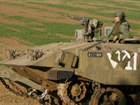 An Israeli soldier sits in a tank near the northern Gaza Strip(Credit: Reuters)