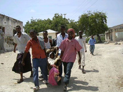 A woman injured during a car bomb explosion is rushed to hospital by her relatives in Mogadishu on Saturday
(Photo: Reuters)